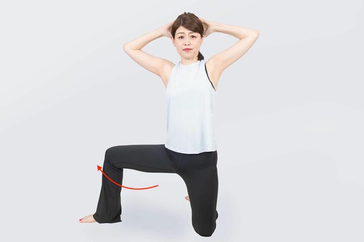 膝立ちした状態で右足を外に開き、両手を頭に置いて両肘を外側に開く