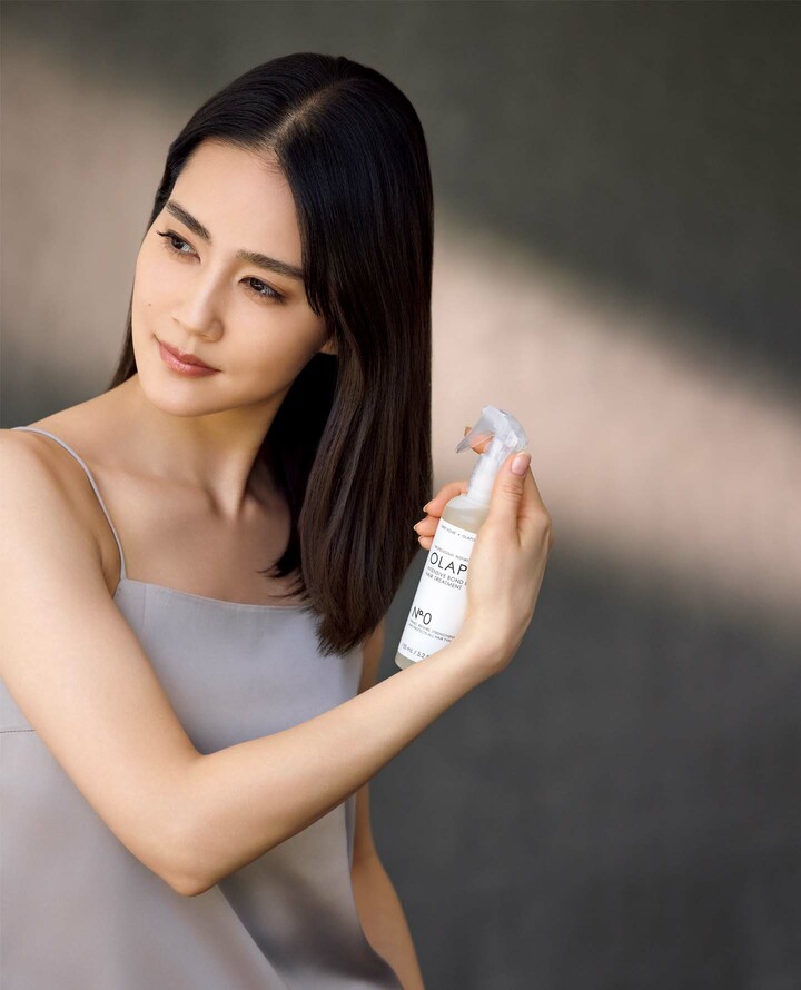 「オラプレックス」の『No.0 インテンシブボンドビルディング ヘアトリートメント』を使用するモデルのAtsukoさん