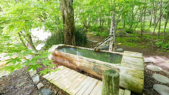 「銀婚湯」の森の中にある「トチニの湯」の丸太風呂。
