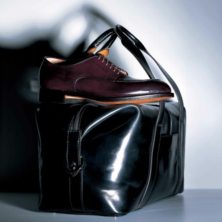 上／言わずと知れたオールデンを代表するVチップは、写真のバーガンディとブラックがあり。¥112,000（ラコタ〈オールデン〉） ※美しく深いツヤと驚くようななじみやすさが特徴のコードヴァンは、雨ジミが残りやすい性質を持っているため、独特のツヤをキープするためにもマメなケアが絶対。
下／希少なコードヴァンを贅沢使いしたボストンバッグは、写真のブラックのほかに、ネイビー（MARINE）があり。内側は、カンガルーレザーを採用。大容量ながら見た目以上に軽量。ショルダーストラップ付き。［縦24×横43×マチ21㎝］¥800,000（ラコタ〈クライス〉）