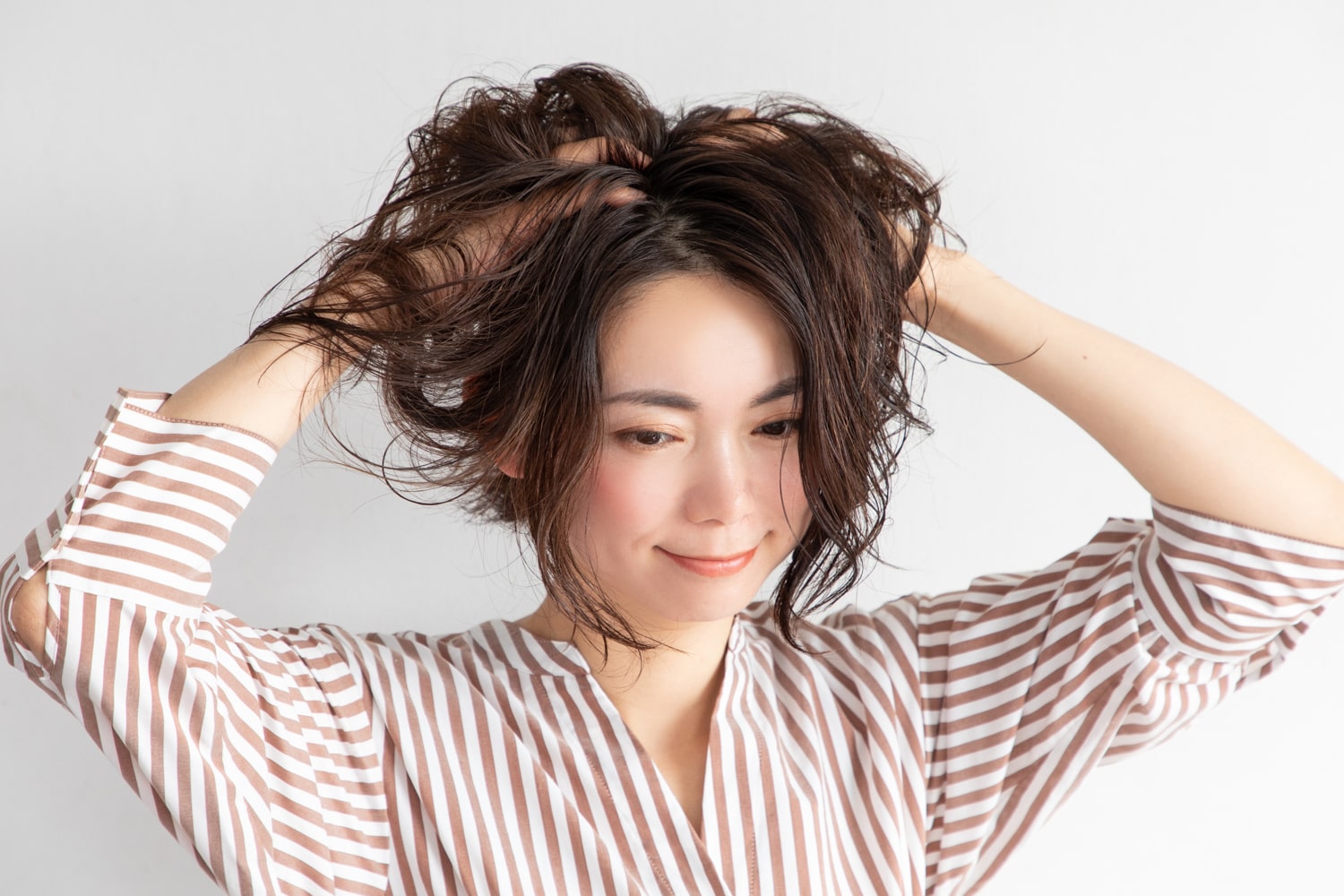 指を立てて頭皮をマッサージするように、髪の根元に指を入れる。手の熱で乾かすイメージで、根元を立ち上げる。