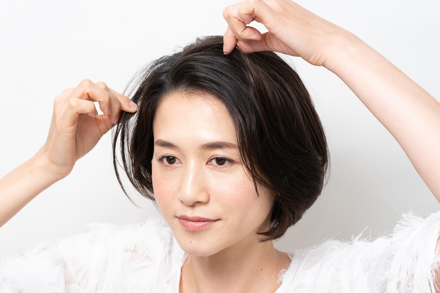 指に残ったワックスで毛束をつまむように、全体のバランスを見ながら整える。