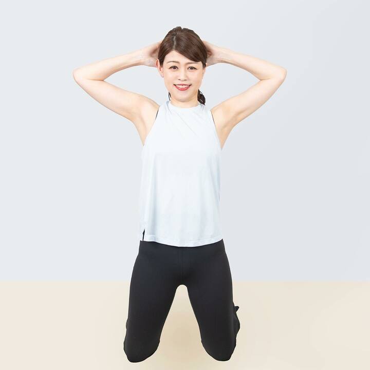 膝立ちをして、両手を後頭部に当てる