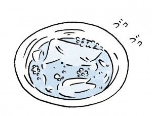 弱アルカリ性の粉末洗剤にしろシャツを浸けているいる様子