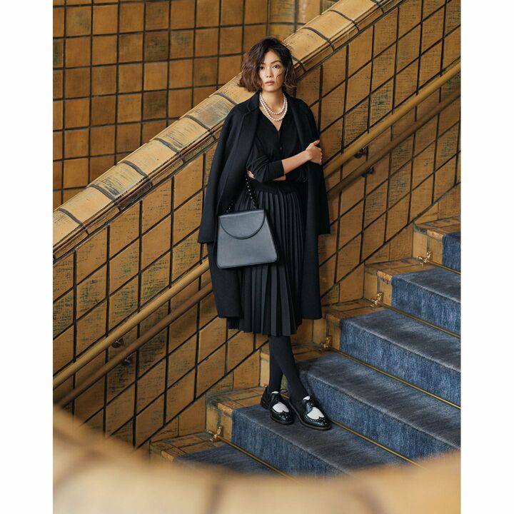 ドラマティックな黒スタイルを無難に見せず、洗練させるのが真逆のイメージをもつメンズ靴。パールの艶やVネックの色気をきゅっと締め、より印象的に。coat：ASTRAET、cardigan：ASTRAET・skirt：ASTRAET、bag：Maryam Nassir Zadeh、necklace：GRANDMATIC、shoes：Robert Clergerie　［2017年Oggi12月号］　撮影／生田昌士