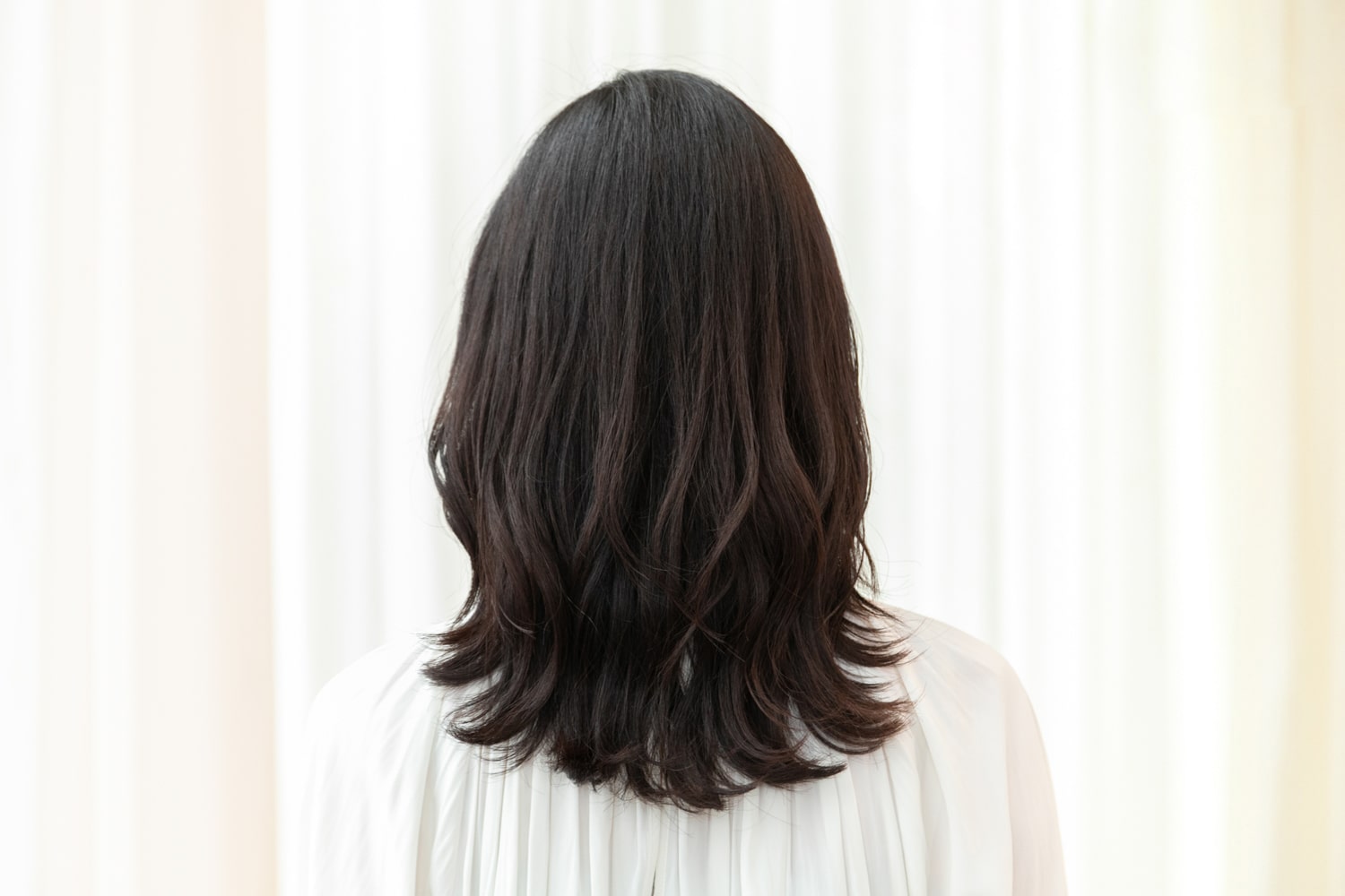 「顔周りとトップにレイヤーを入れ、ふんわりとしたボリューム感と菱形フォルムの丸みを作りました。クセが強めなので、毛量を取り過ぎると悪目立ちすることに。クセの動きをいかしつつ、シルエットをコントロールするカットを施しています」(徳永さん)