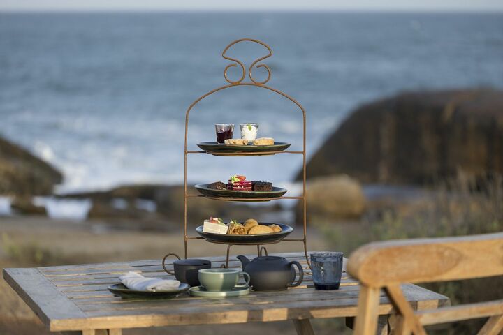 海辺に用意されたハイティー。スクエアのパンを重ねてトップに薄くスライスしたきゅうりを並べた、ショートケーキのようなルックスのキューカンバーサンドがキュート。