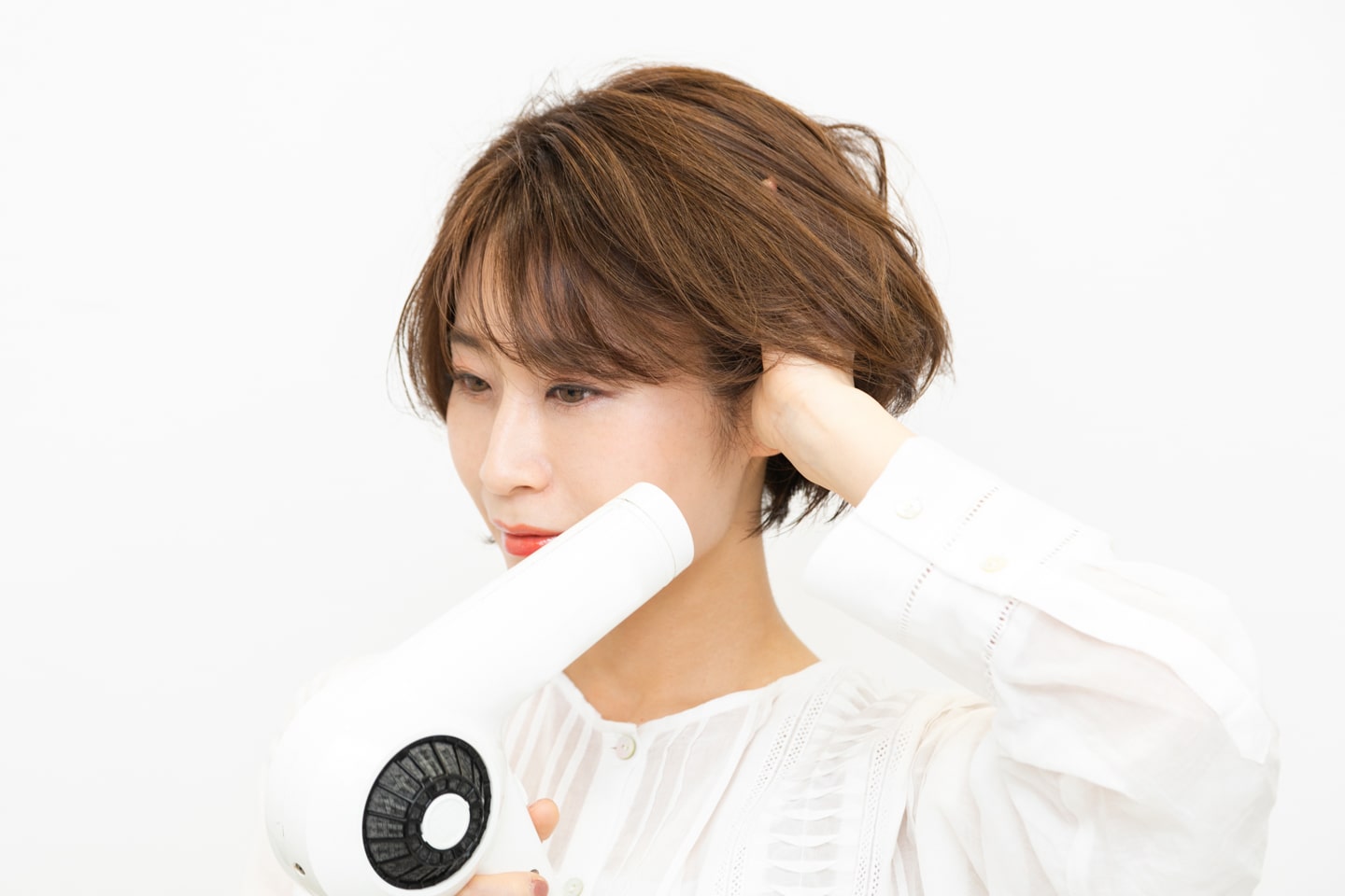 横にボリュームが出るように、サイドの根元に指を入れて起こしながら乾かす。