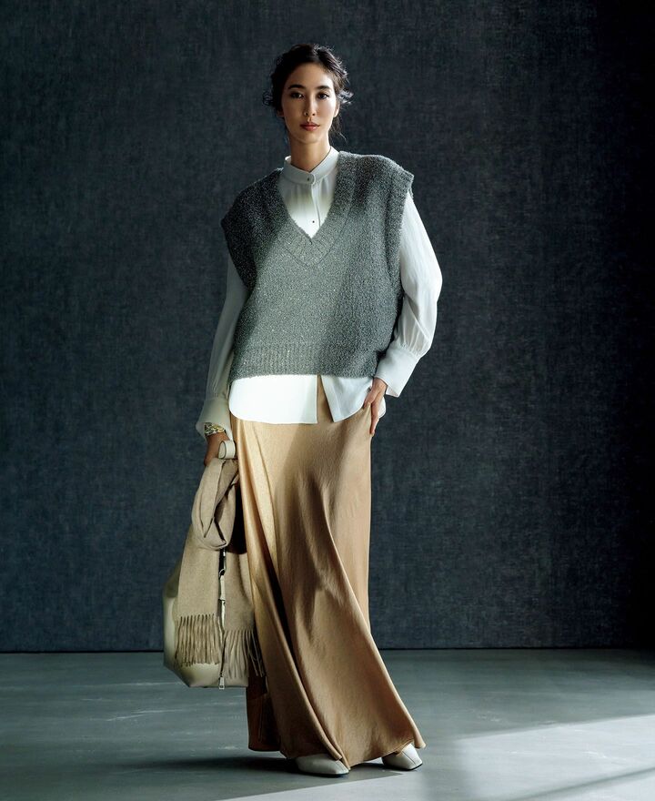 サテンブラウスにラメニットを重ねて着用したモデルの立野リカさん