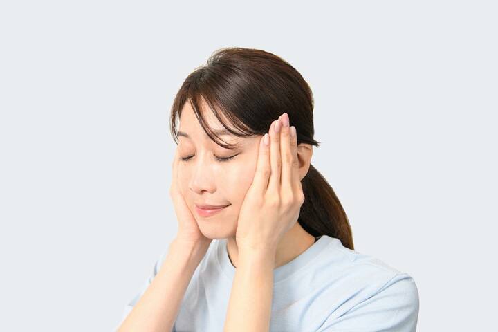 温めた手で耳の手前を包むように当て、深呼吸を3回行う