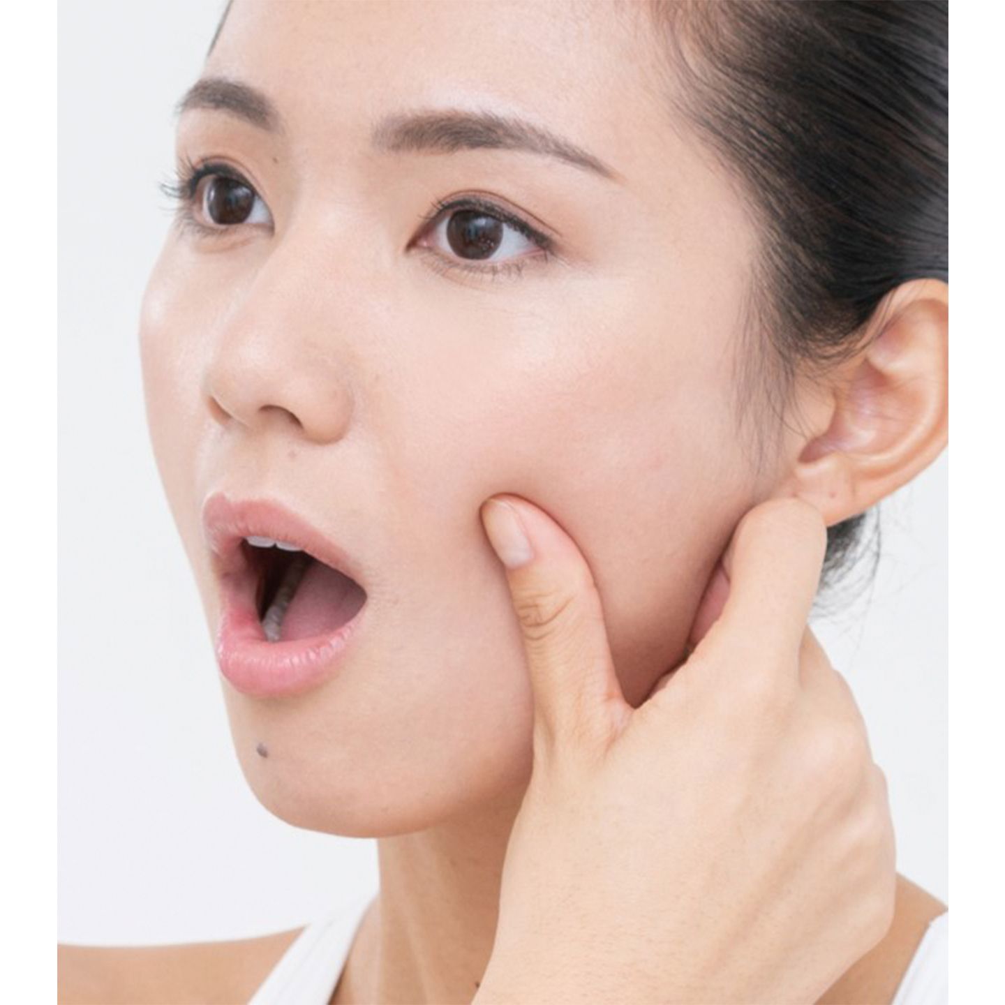咬筋をしっかりはさみ押さえながら、口を開ける。