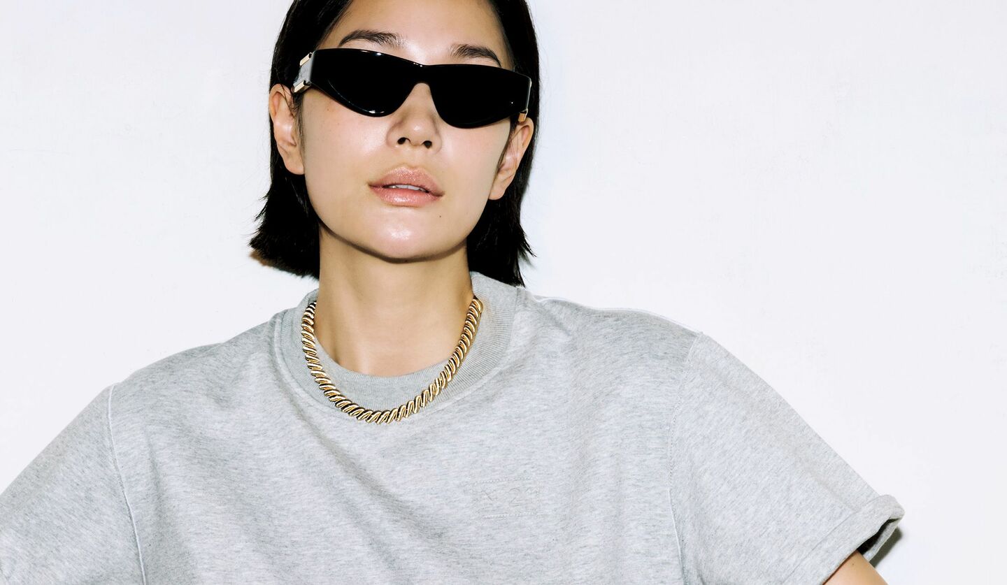 「ブチェラッティ」のジュエリーとTシャツを着用したモデル
