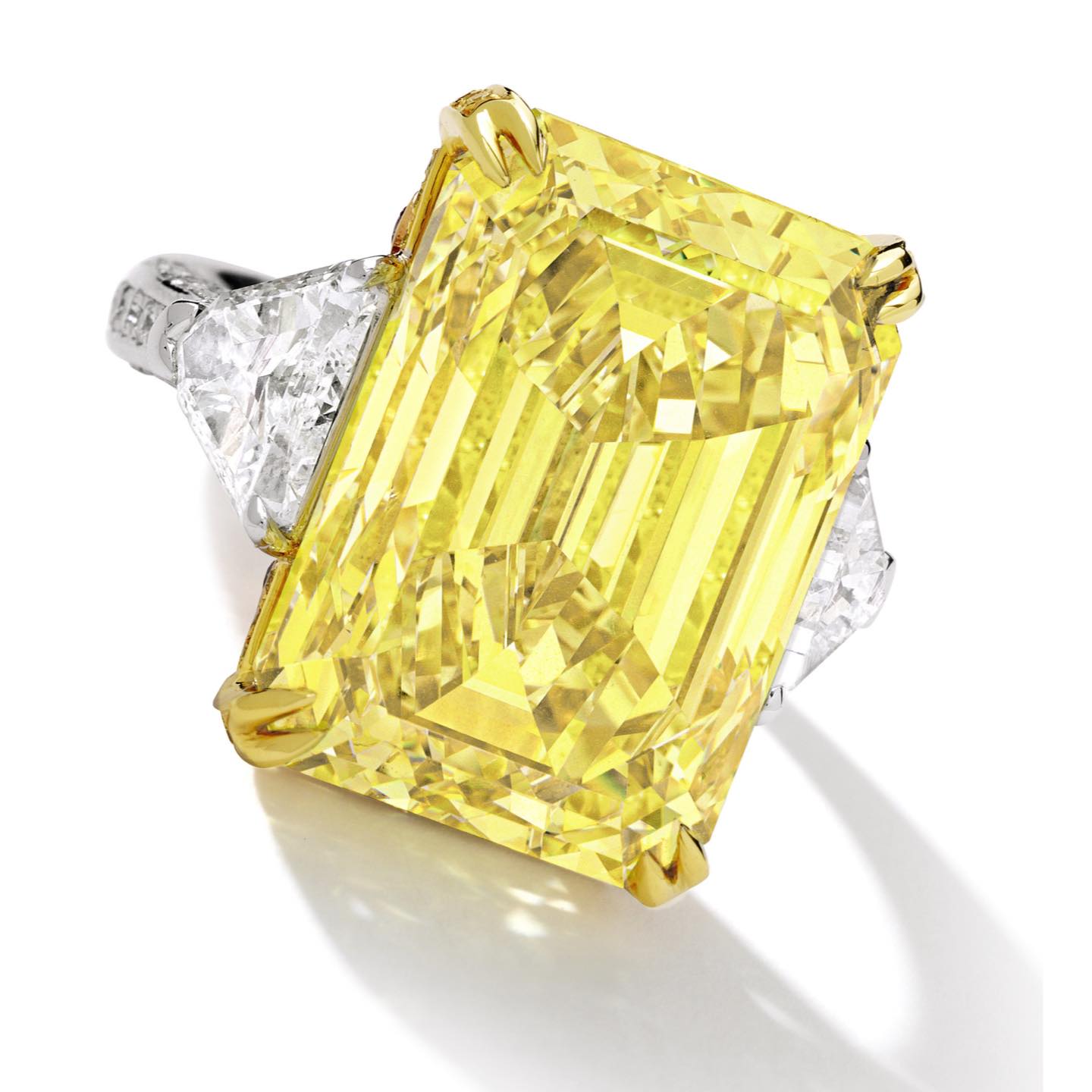 An Impressive Fancy Vivid Yellow Diamond and Diamond Ring