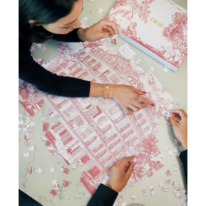 〝クリスチャン ディオール〟発祥の地でもあるパリの本店「30 モンテーニュ」をモチーフとしたジグソーパズル。繊細なタッチの絵柄は実にアーティスティックで、部屋に飾る楽しみも。計1,000ピース構成で、親しいパートナーや家族へ〝密度の濃い時間〟をプレゼントできる。パズル『ディオール ジグソーパズル 30 モンテーニュ』￥28,600（クリスチャン ディオール〈ディオール メゾン〉）　［レディス］〝ディオール〟のニット￥165,000・〝ディオール ファイン ジュエリー〟のブレスレット［手首側から］￥847,000・￥451,000・リング￥133,100（クリスチャン ディオール）　［メンズ］シャツ￥121,000（クリスチャン ディオール〈ディオール〉）