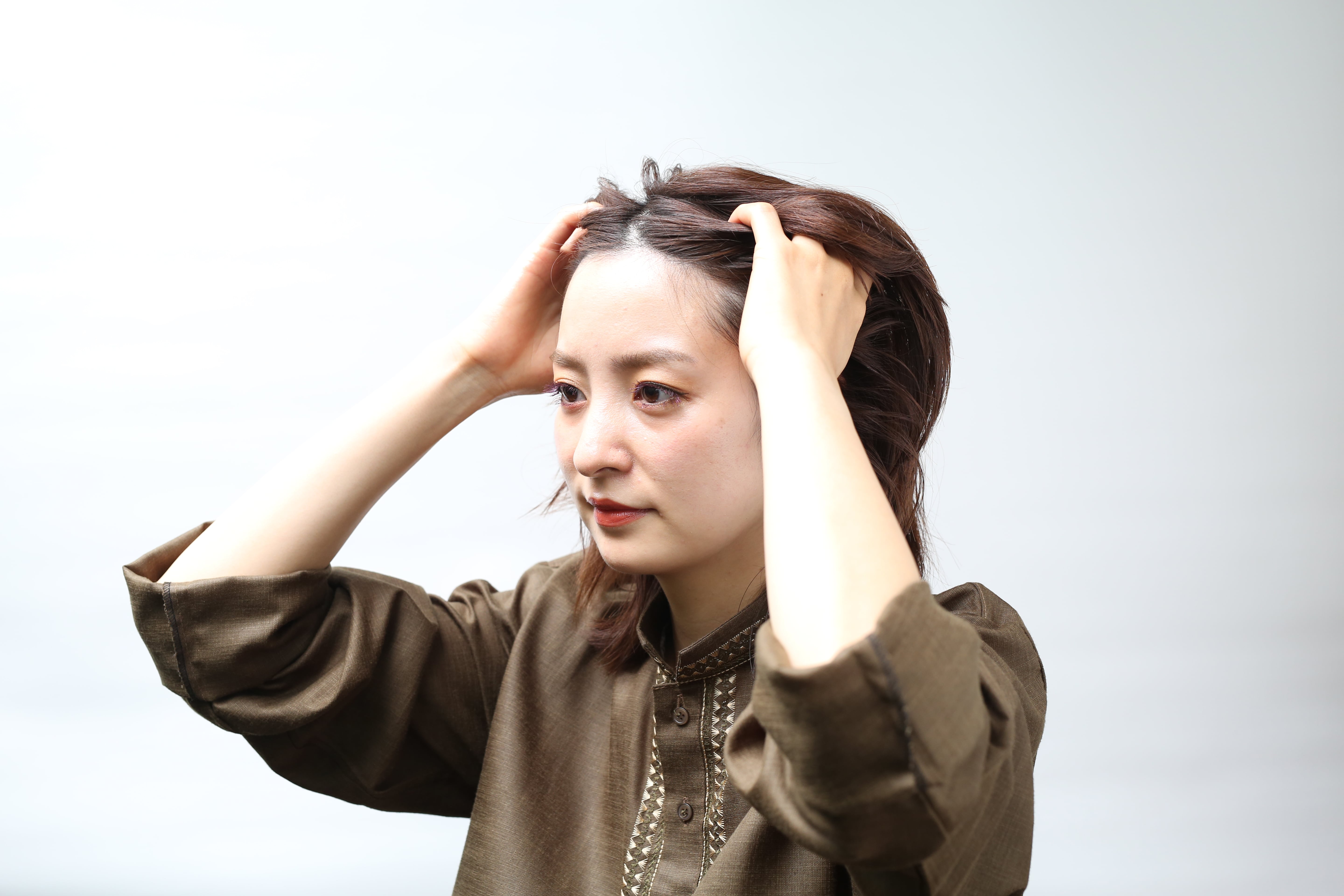 アレンジの前に髪のボワつきを抑えるため、全体的にヘアクリームをつけていく。髪の内側を中心にしっかりとなじませて。