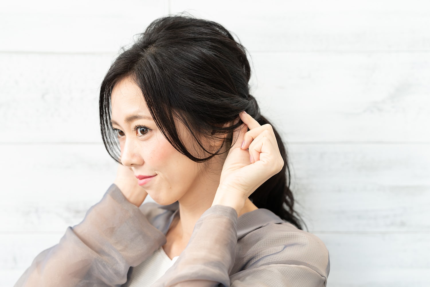 耳にゆるっとかかるくらいを目安にねじった毛束からも、髪を引き出して。出しすぎると疲れて見えるので、耳が透けて見えるくらいを意識すると◎。