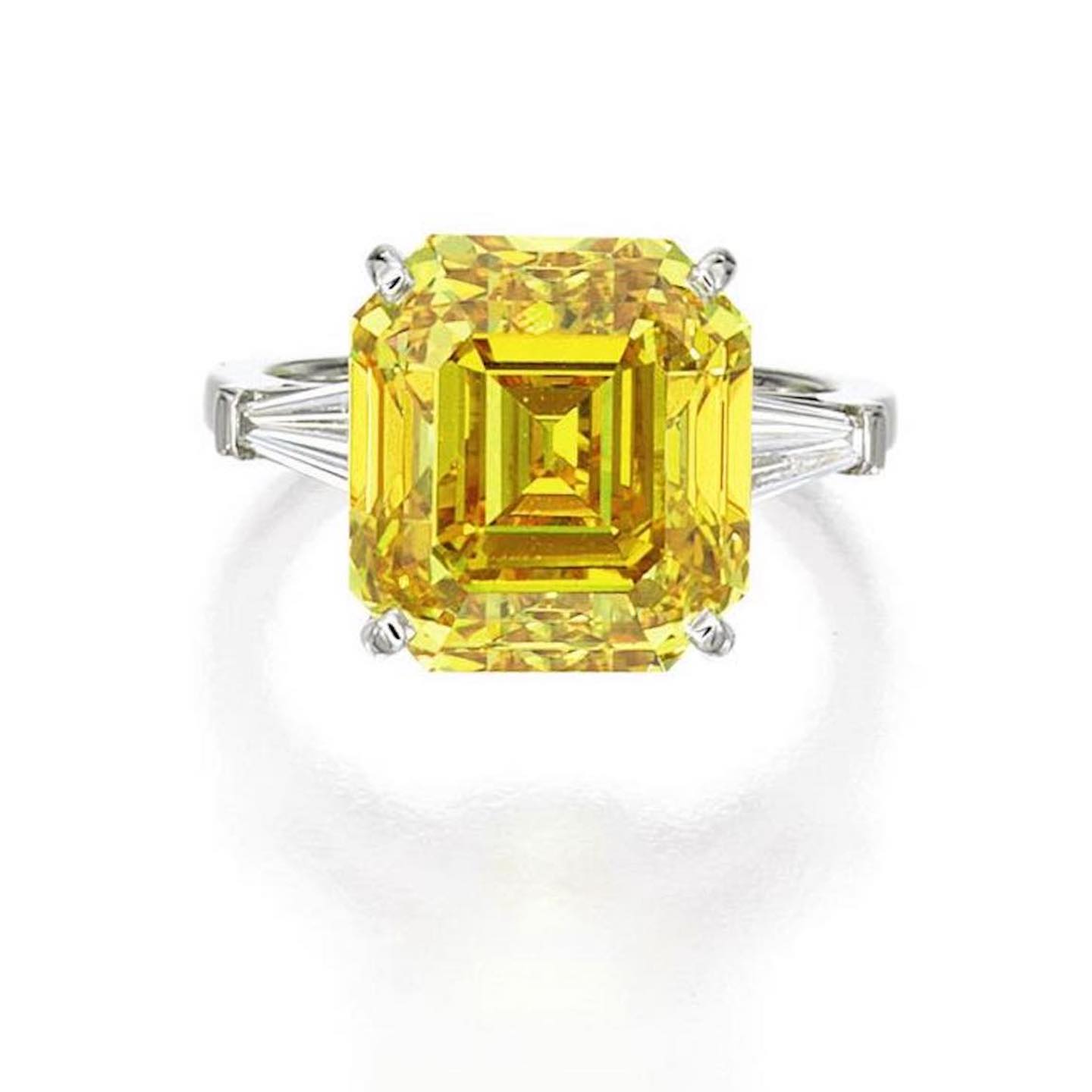 An Important Fancy Vivid Orangy Yellow Diamond and Diamond Ring