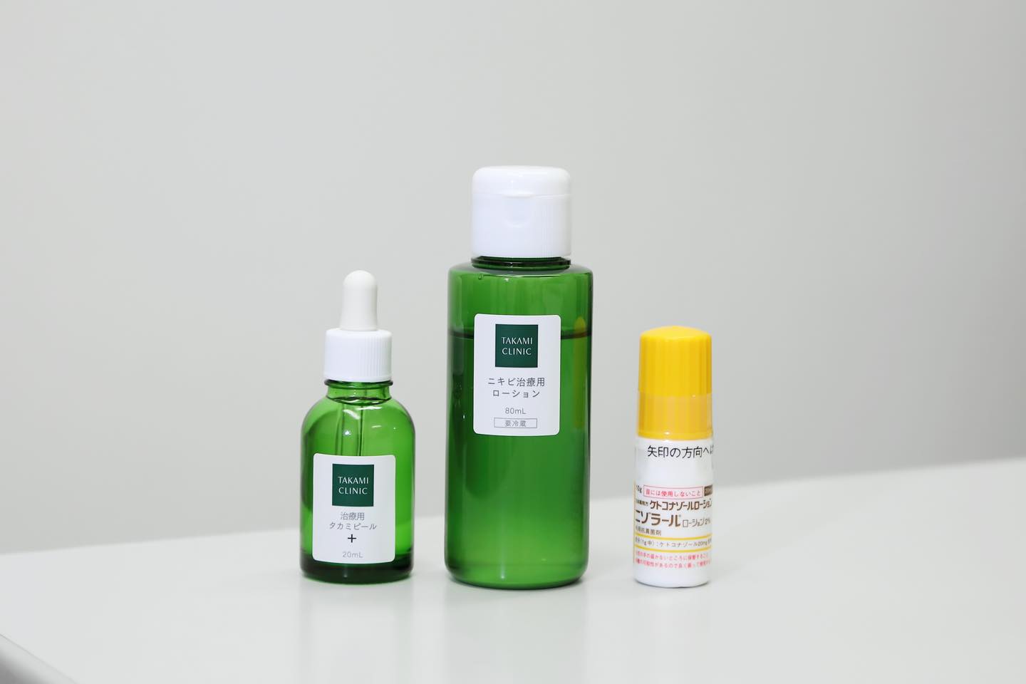 左から/薬剤・抗炎症成分・美容成分を配合し、美肌効果も兼ね備えたオリジナルのピーリング薬。ターンオーバーの正常化&皮脂抑制効果で、今あるニキビを改善し、毛詰まりも軽減。タカミクリニック 治療用タカミピール + 20ml ¥3,665、抗生剤・男性ホルモン抑制剤・抗炎症成分・高濃度ビタミンC誘導体・植物由来女性ホルモン様成分などを配合した治療用化粧水。治療とスキンケアが同時に行えるオールインワン処方。同 ニキビ治療用ローション 80ml ¥8,000円、脂漏性皮膚炎の治療薬として処方。ニゾラールローション ¥1,000円(処方薬)