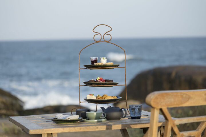 海辺に用意されたハイティー。スクエアのパンを重ねてトップに薄くスライスしたきゅうりを並べた、ショートケーキのようなルックスのキューカンバーサンドがキュート。