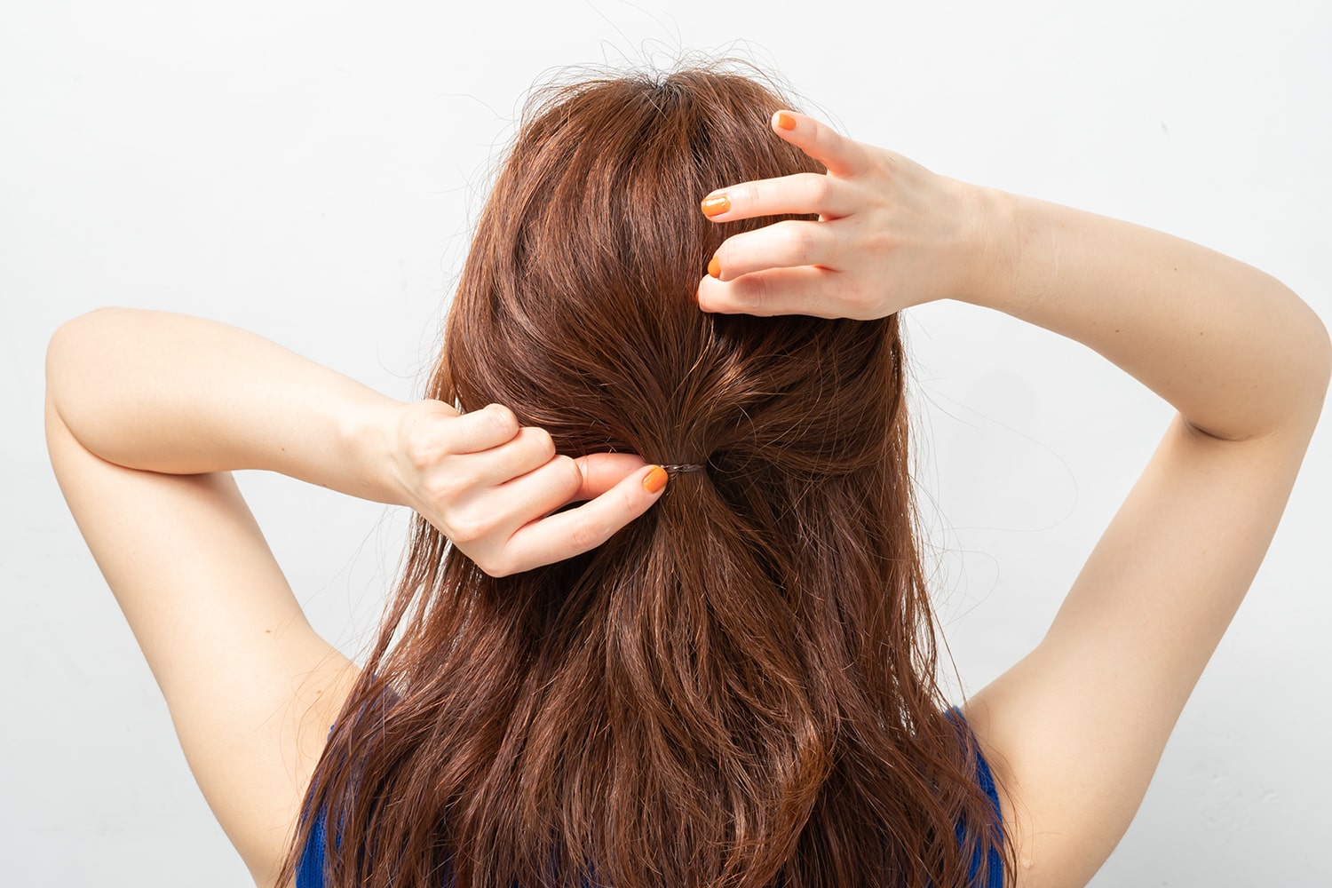 髪の表面ではなく、内側からランダムに毛束を引き出す。その後、バレッタなどのヘアアクセサリーでゴムを隠す。