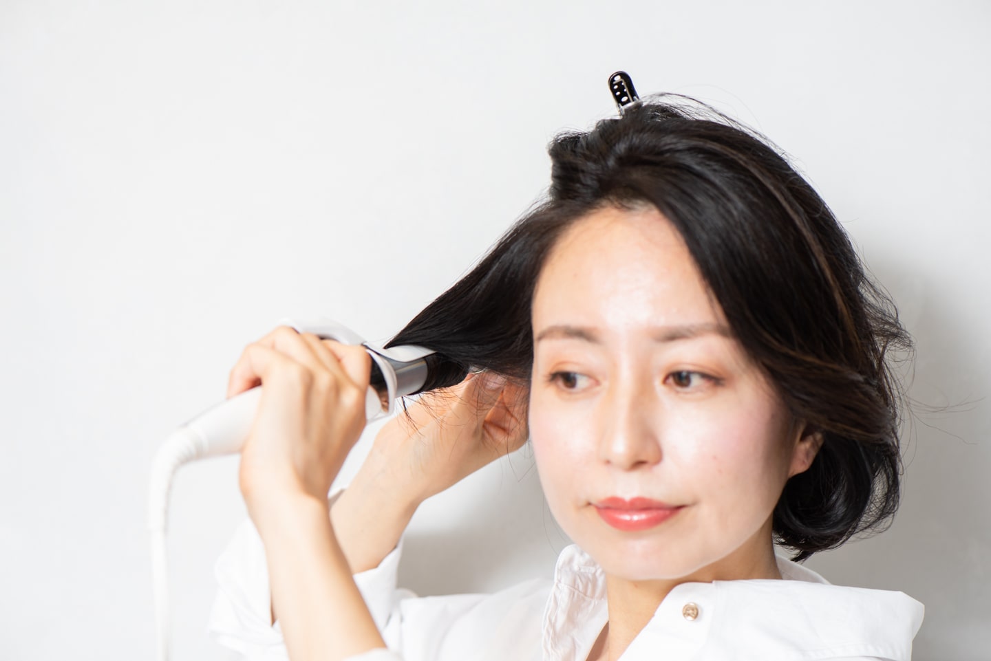 26mmのヘアアイロンを使用。ハチ下の髪を持ち上げながら、毛先からワンカール巻く。