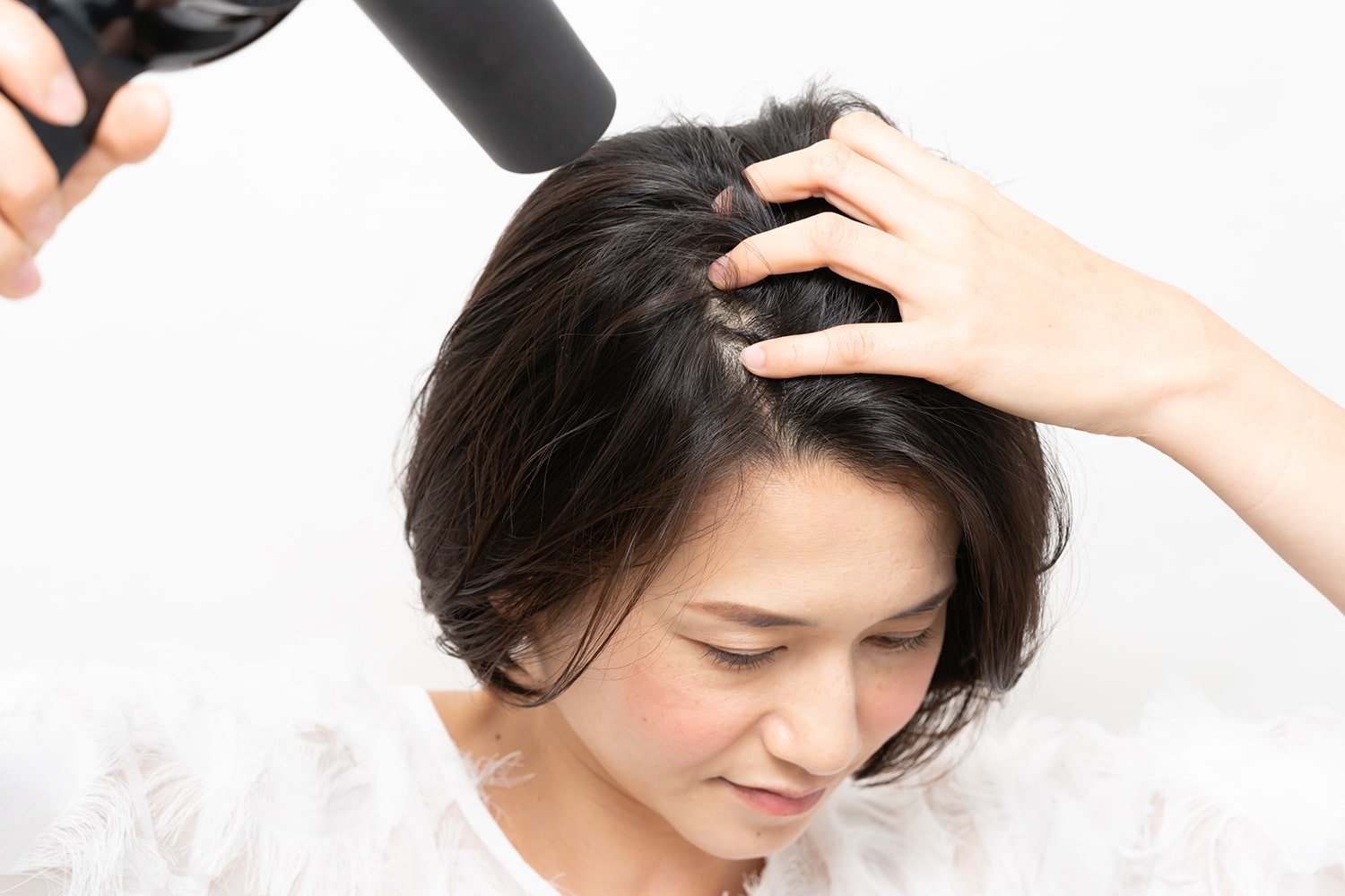 指の腹で地肌をこするようにドライする。後ろから前に乾かすと、顔を上げた時にふわっと根元が起きる。